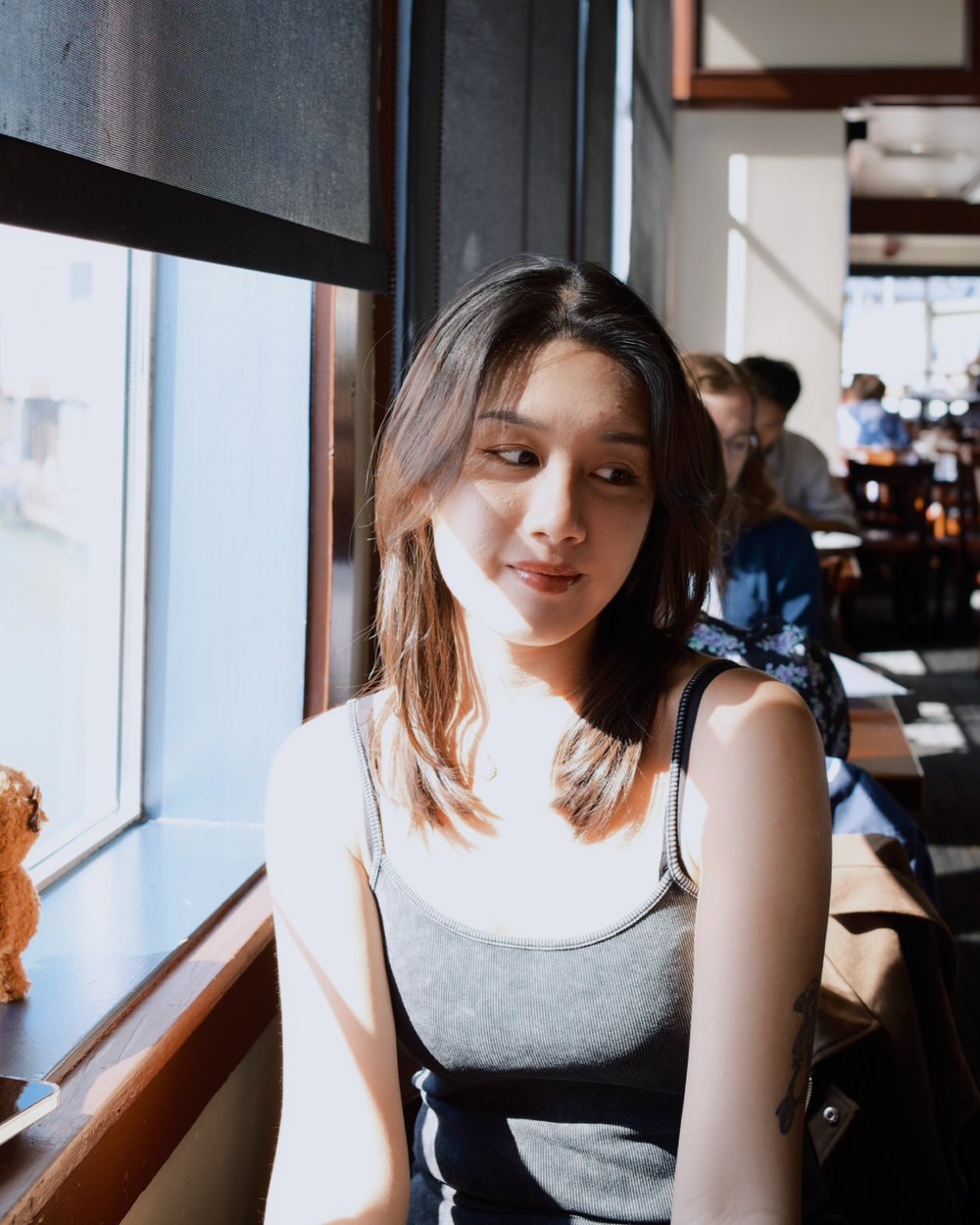 Lesley Chung sitting by a sunlit window