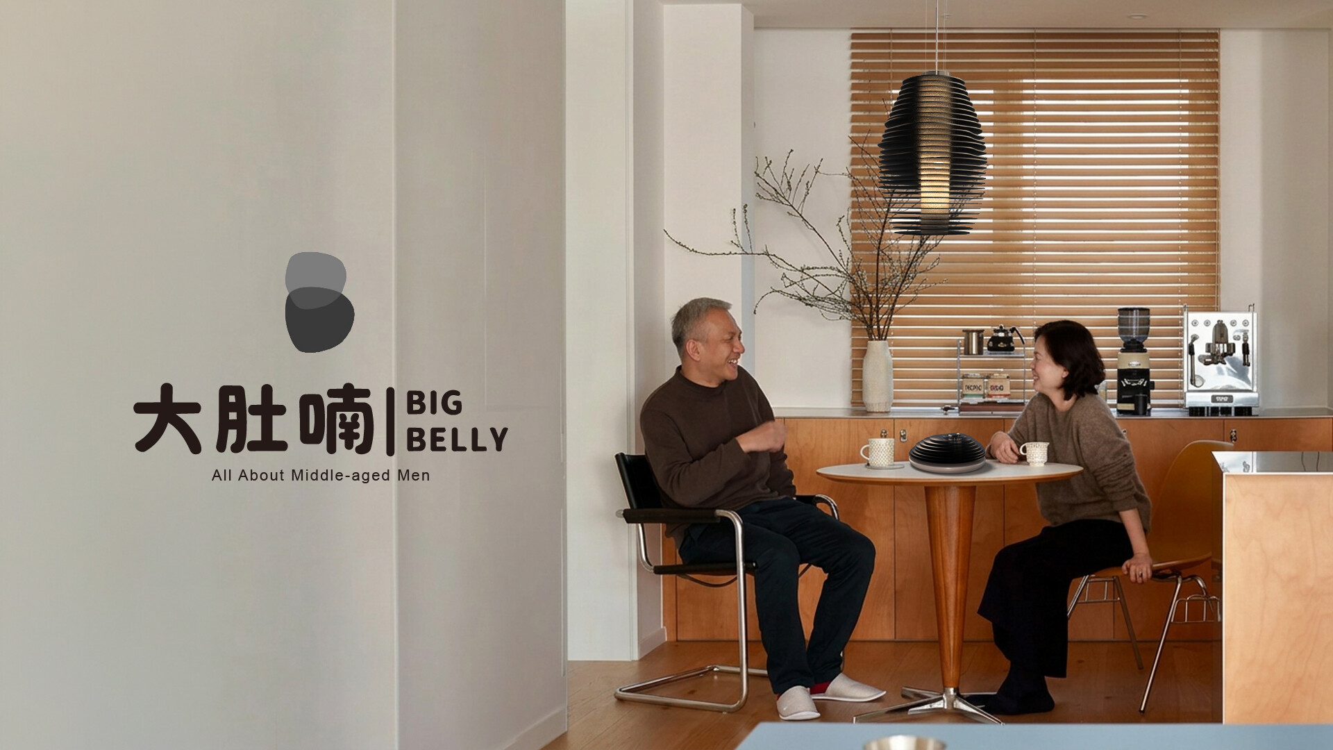 Big Belly logo beside a couple at a dining table under the pendant lamp