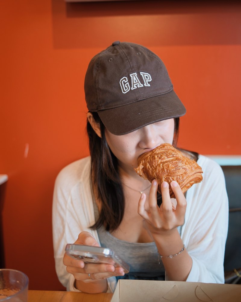 Lesley biting into a pastry